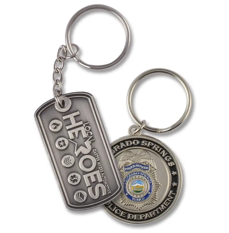 Two silver metal dog-tag keychains with embossed lettering and Colorado Springs Police Department badge artwork