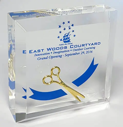 Lucite grand opening award with miniature ribbon cutting scissors inside