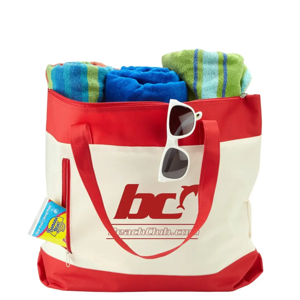 Red and cream beach tote bag with a custom logo, filled with beach towels